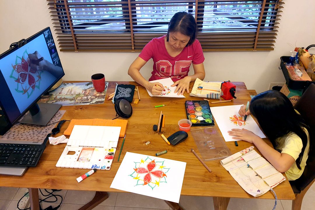 A mother and daughter immersing themselves in Mandala art. [Photograph by Ng Kok Hoong]