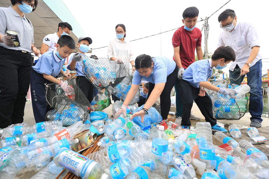 The children of Tzu Chi Parent-Child Bonding Class segregating the recyclables under the guidance of their parents. [Photograph by Thin Ket Yong]