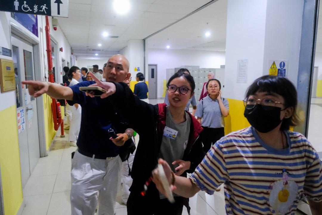 学生随着导览人员走进校园，沿途认识校园环境，对大学生活展开更多想像。 【摄影：林子淇】