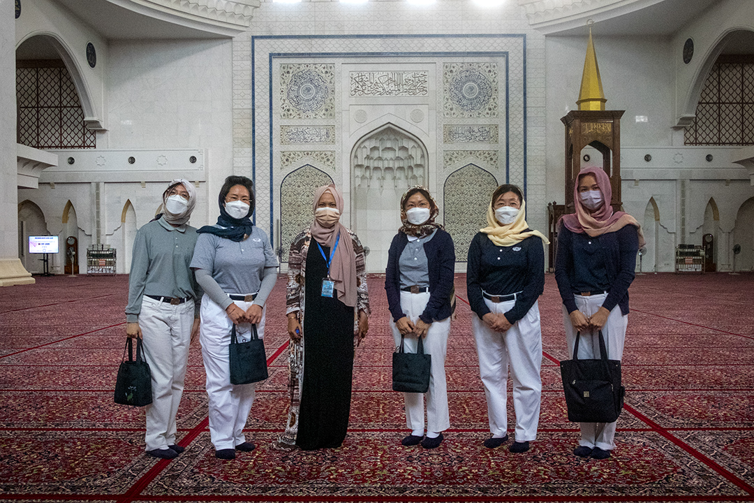 Azlin (third from left) encouraged each person in her group to reflect on one’s feelings as they entered the serene prayer hall. [Photo by Niki Leng]