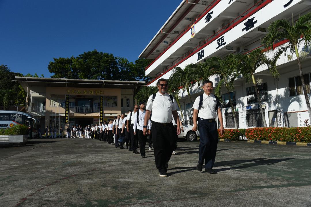 巴士抵达义诊场地拿笃中学后，慈济志工井然有序地排列成队，以整齐的步伐进入校园。 【摄影：蔡梦萍】